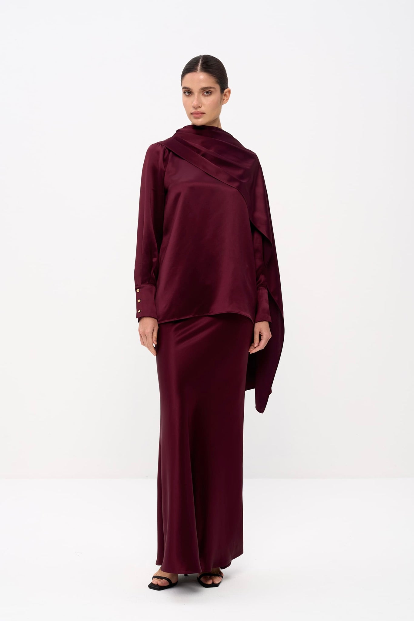 Woman wearing a burgundy outfit on a white background