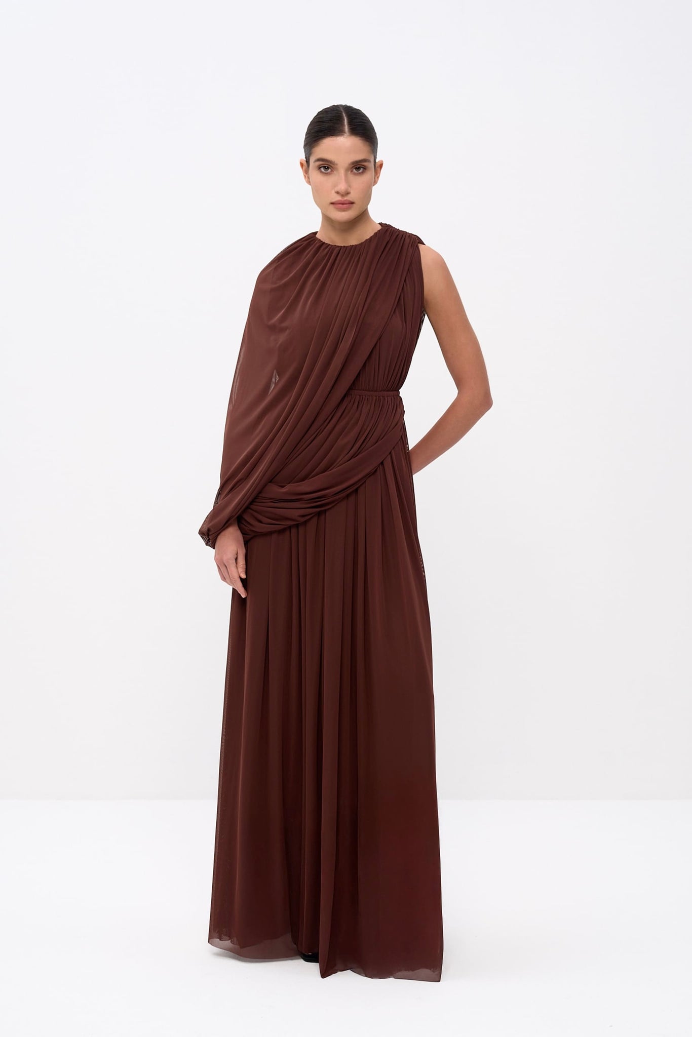 Woman wearing a brown sleeveless dress on a white background