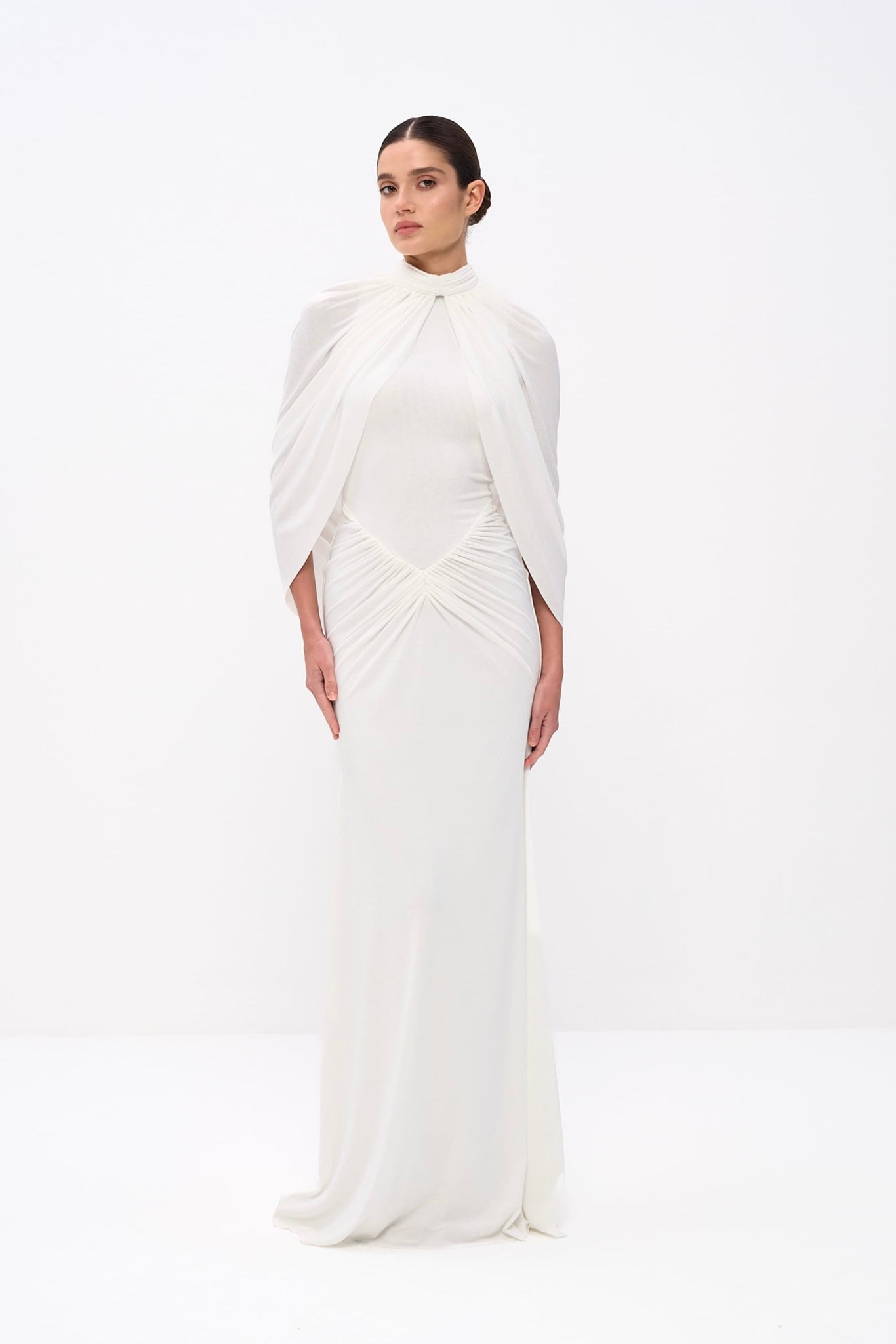 Woman wearing a white saree on a white background
