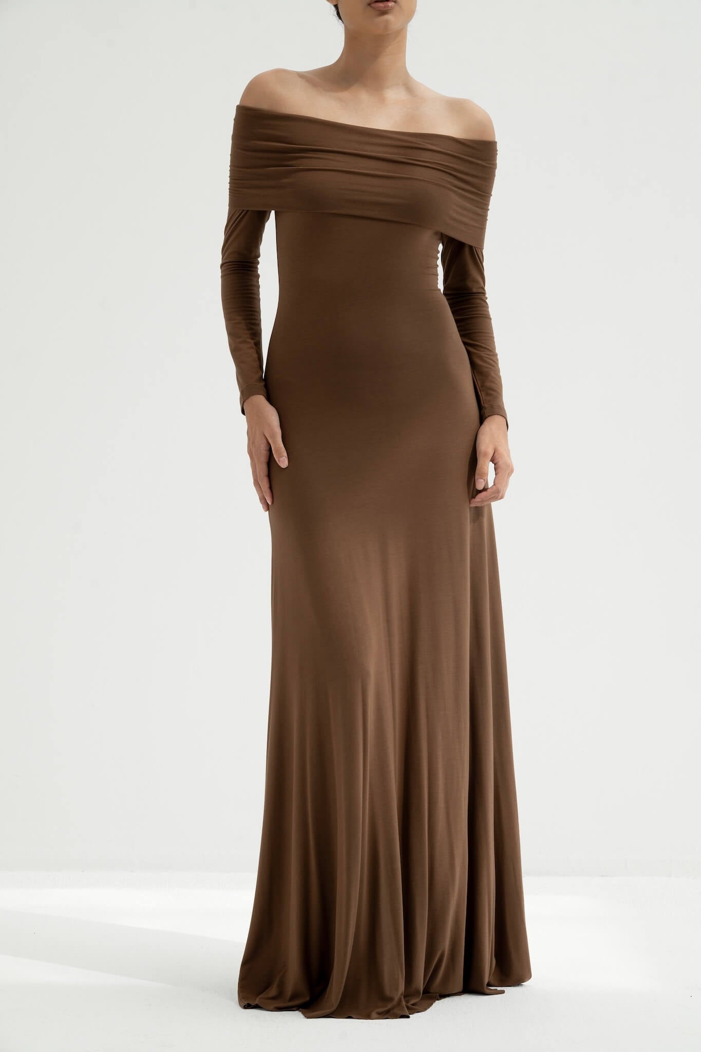 Brown off-shoulder gown on a white background