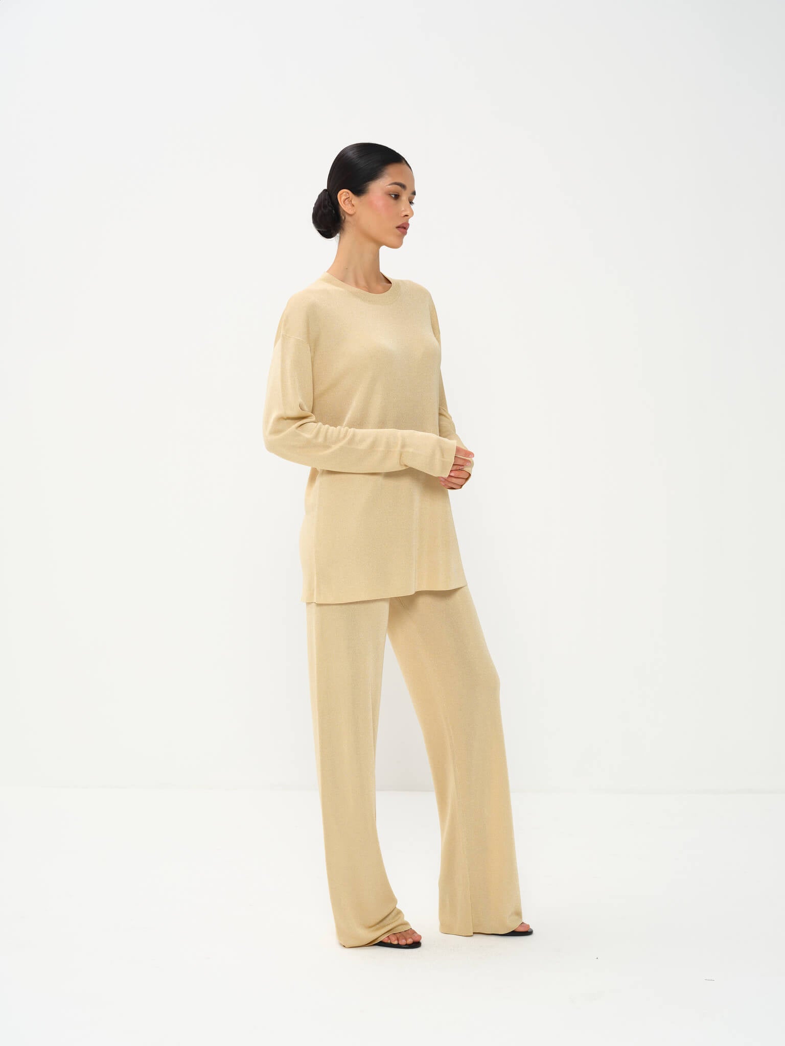 Woman wearing a beige outfit on a white background