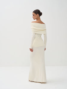 Woman wearing a white off-shoulder dress on a white background