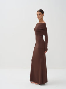 Woman wearing a brown off-shoulder dress on a white background