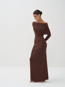 Woman wearing a brown off-shoulder dress on a white background
