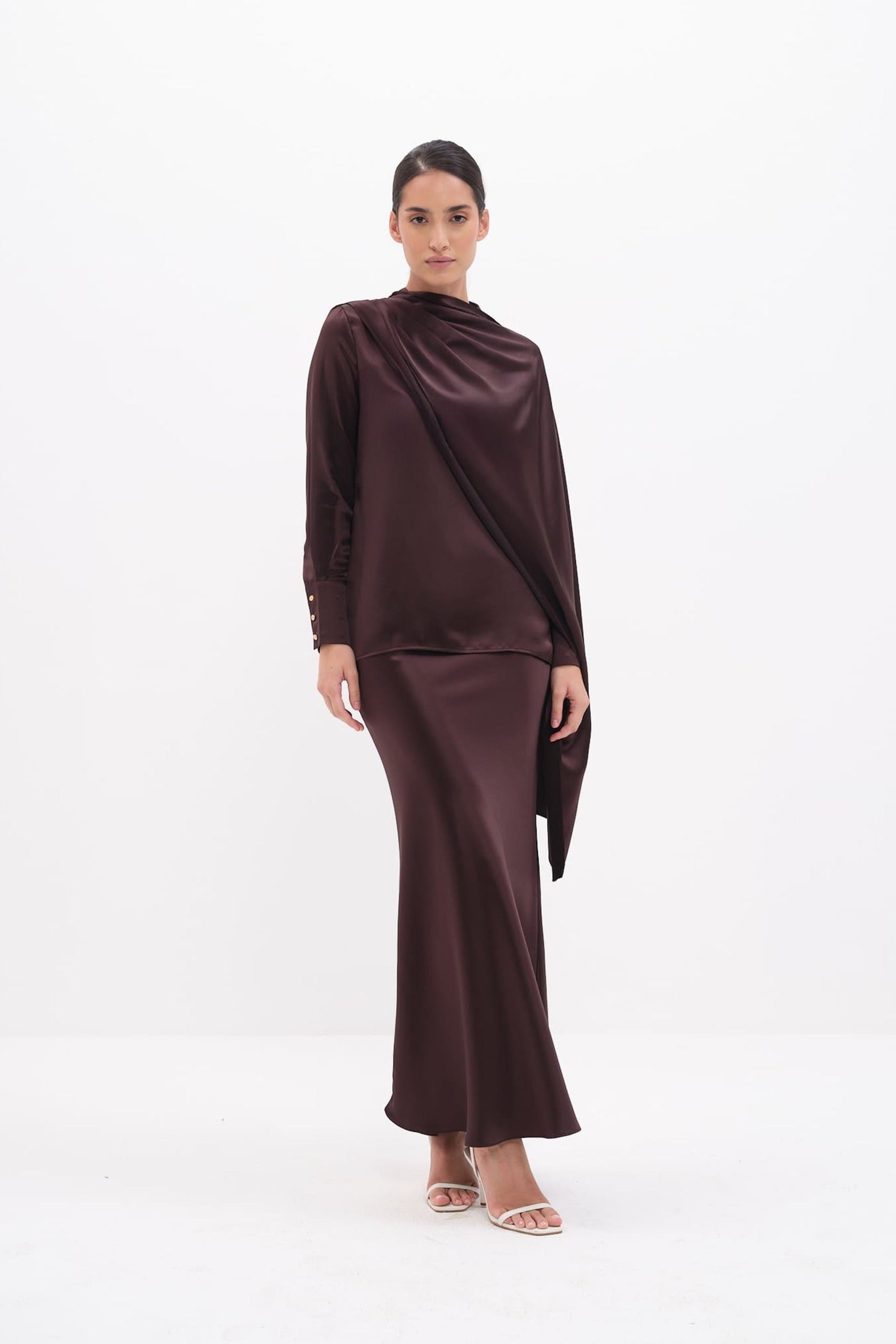 Woman wearing a brown dress on a white background