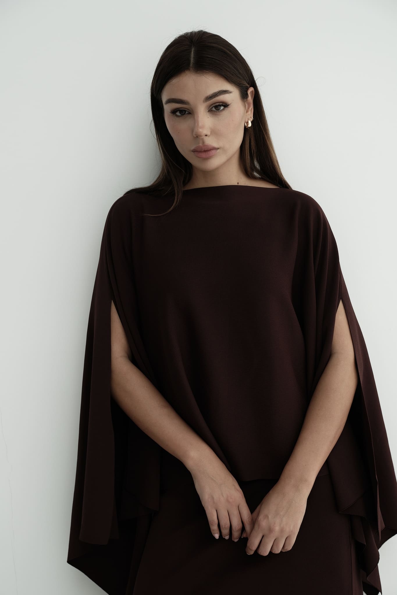 Model wearing Amanda Set featuring a draped cape top and a matching floor-length skirt, styled with white strappy sandals, standing against a white background