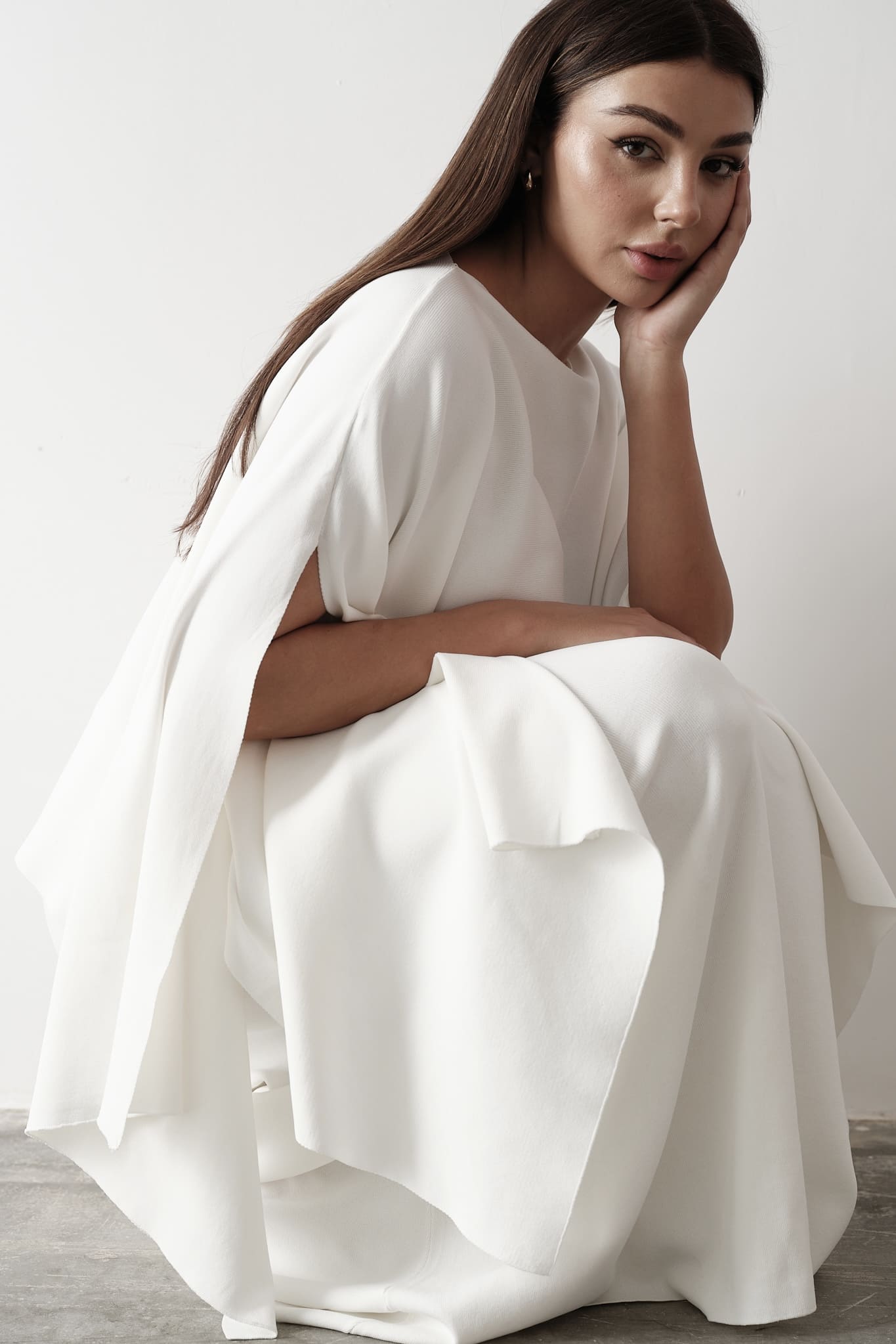 Model wearing Amanda Set featuring a draped cape top and a matching floor-length skirt, styled with white strappy sandals, standing against a white background