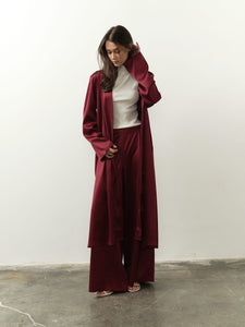 Talisa Set: Elegant burgundy satin full-length robe with wide-leg trousers, designed for effortless movement and modern sophistication.