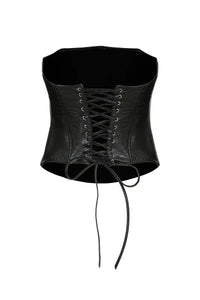 The Imari Corset, a timeless essential, is displayed against a plain white backdrop. This black leather corset boasts a lace-up front and detailed craftsmanship. Its slightly curved top edge and tapered bottom contour to create a cinched waist. The long laces are left loose at the ends for an adjustable fit.