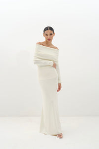 Woman wearing a white off-shoulder set against a white background