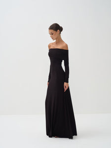 Woman wearing a black off-shoulder long-sleeve gown on a white background