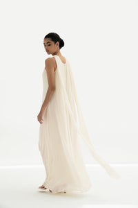 Woman wearing a long white dress against a white background