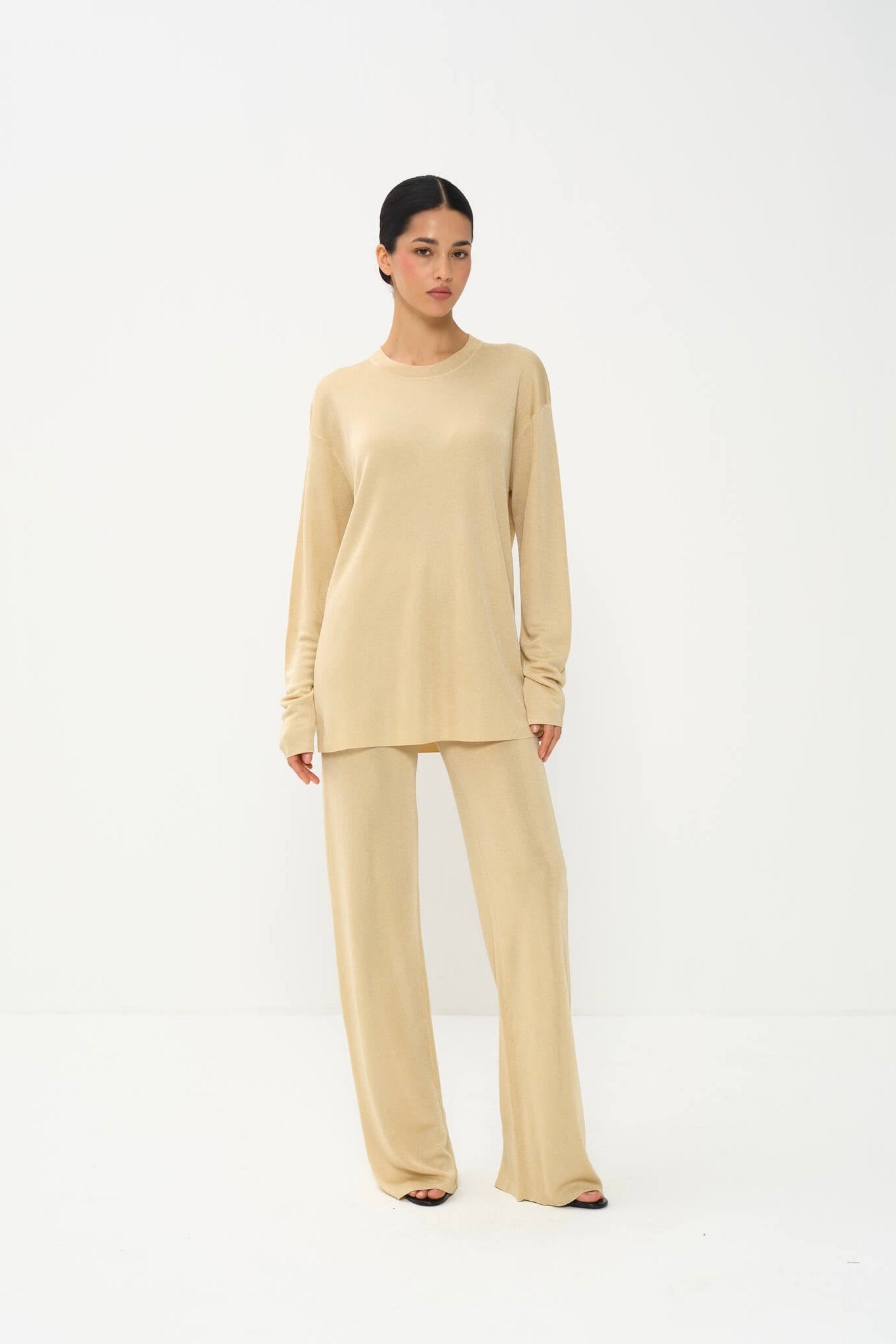 Woman wearing a beige outfit on a white background